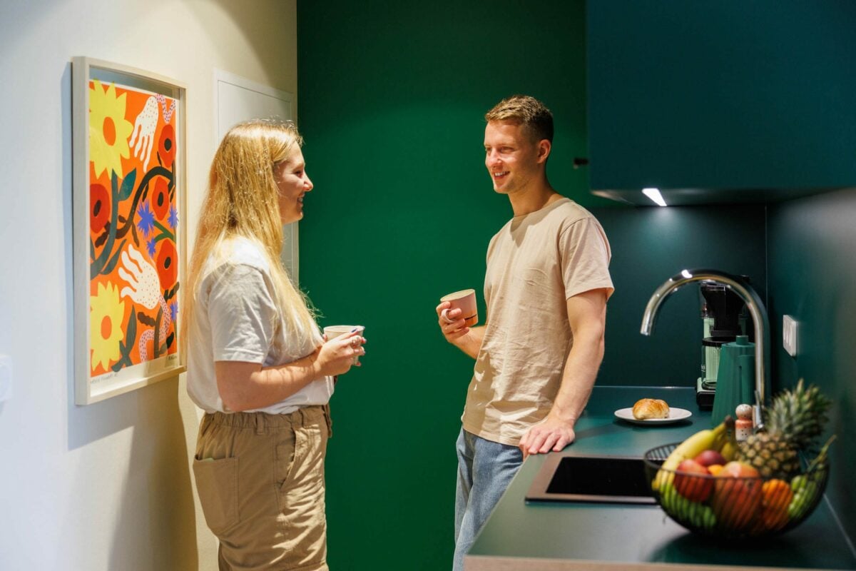 two people talking in a kitchen